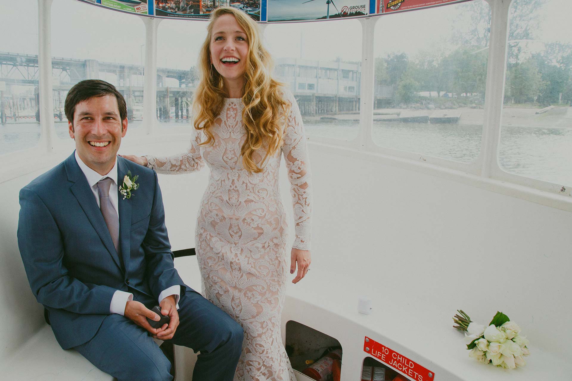 newlywed couple smiling on the Aquabus in Vancouver, BC