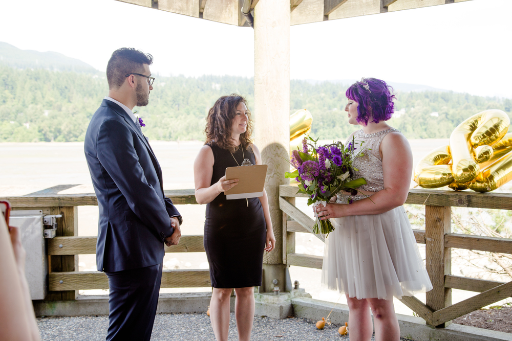 Young Hip & Married Officiant Lani marrying a couple under the gazebo at Rocky Point Park, a perfect rainy wedding day location in Vancouver
