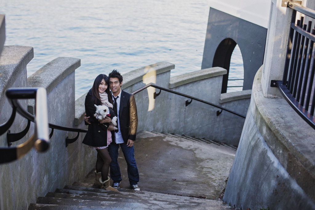 Newlywed couple posing on the stairs of the Brockton Point Lighthouse in Stanley Park