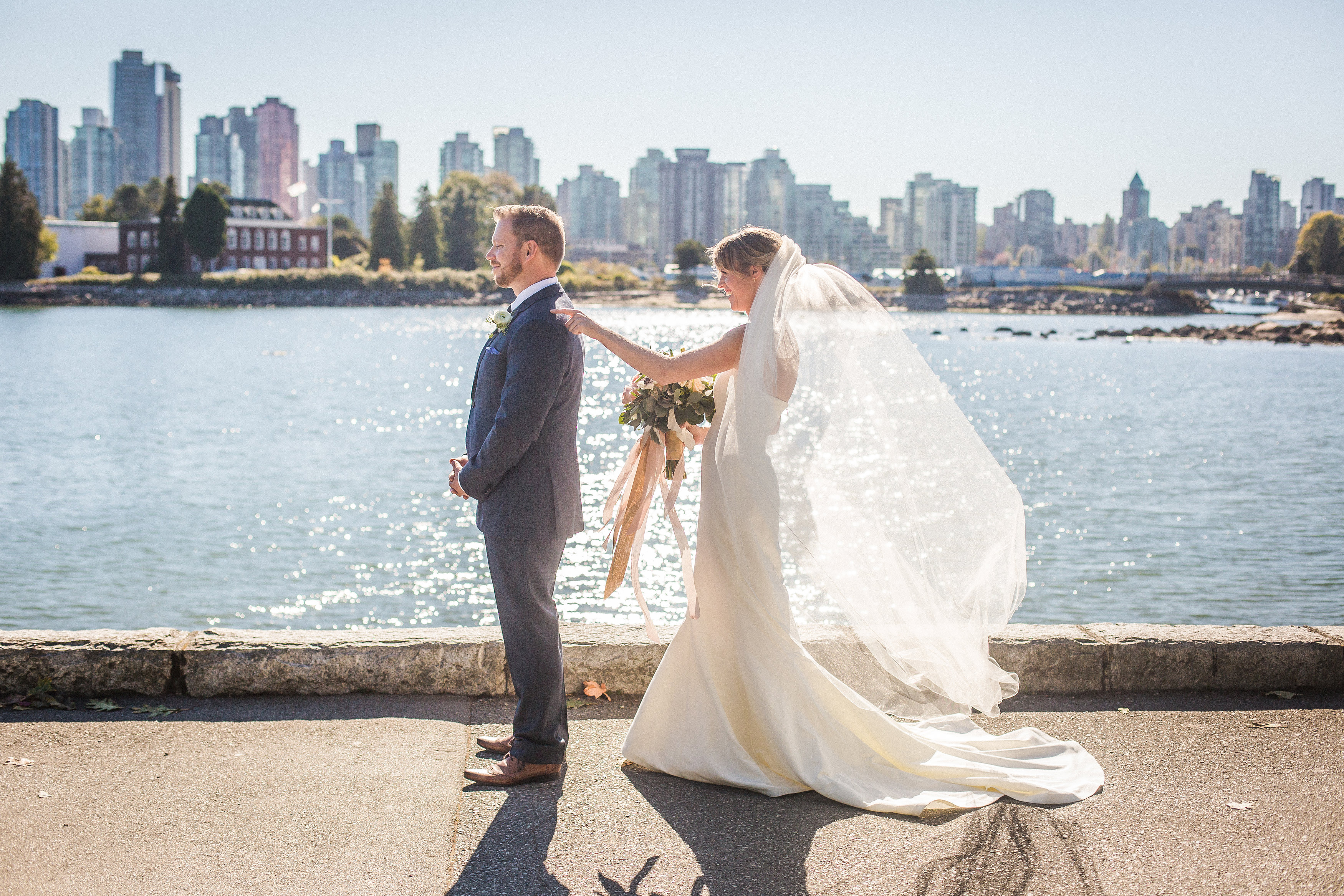 Vancouver couple doing the first look on their wedding day on the Vancouver Seawall