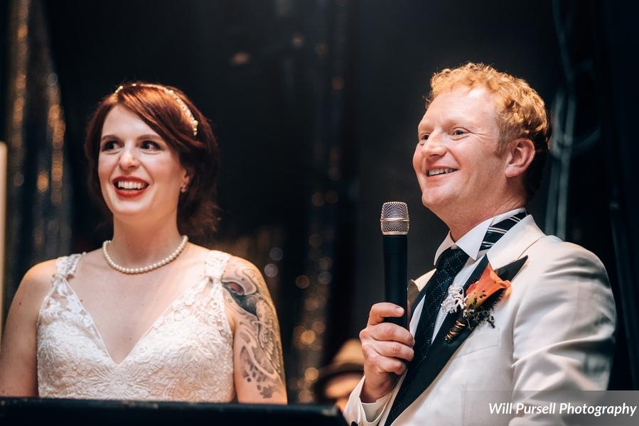 giving a wedding speech at their wedding reception