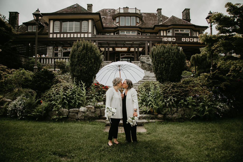Newlyweds kissing in the rain at Cecil Green in Vancouver