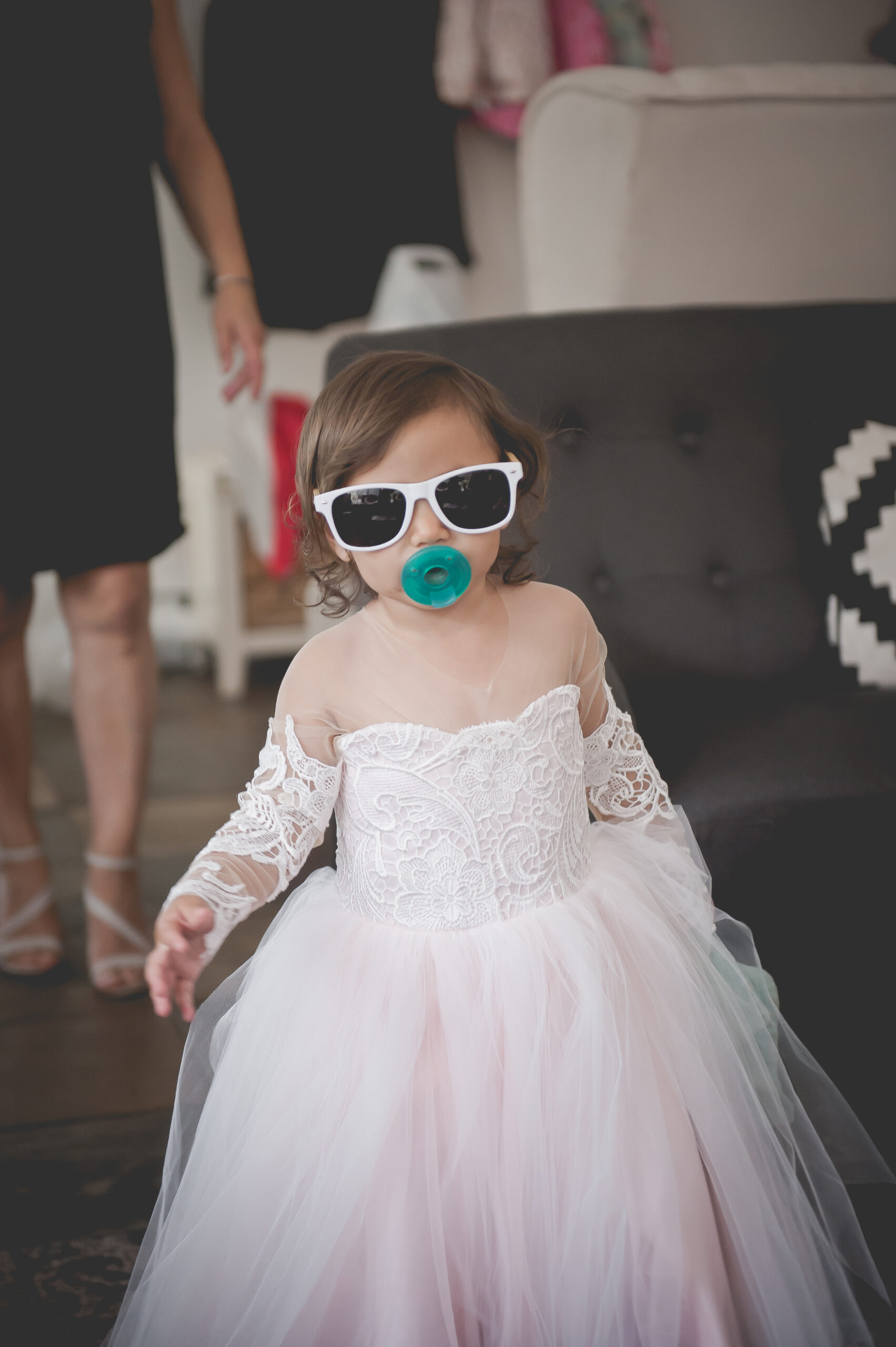 flower girl with sunglasses and a pacifier