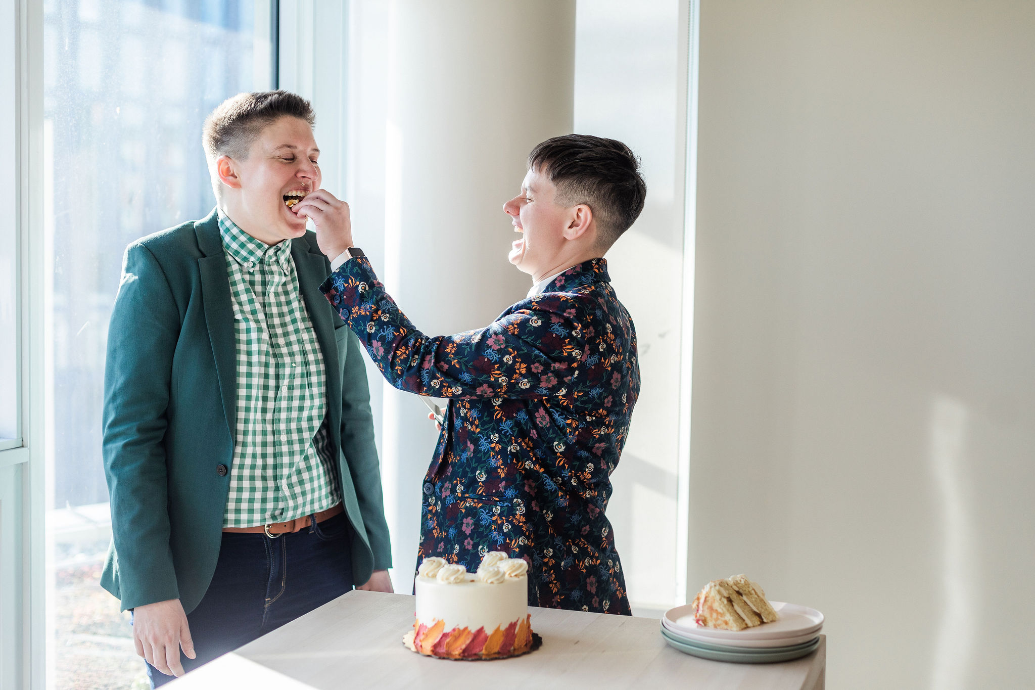 queer couple eating wedding cake, find lgbtq friendly wedding vendors in 2023