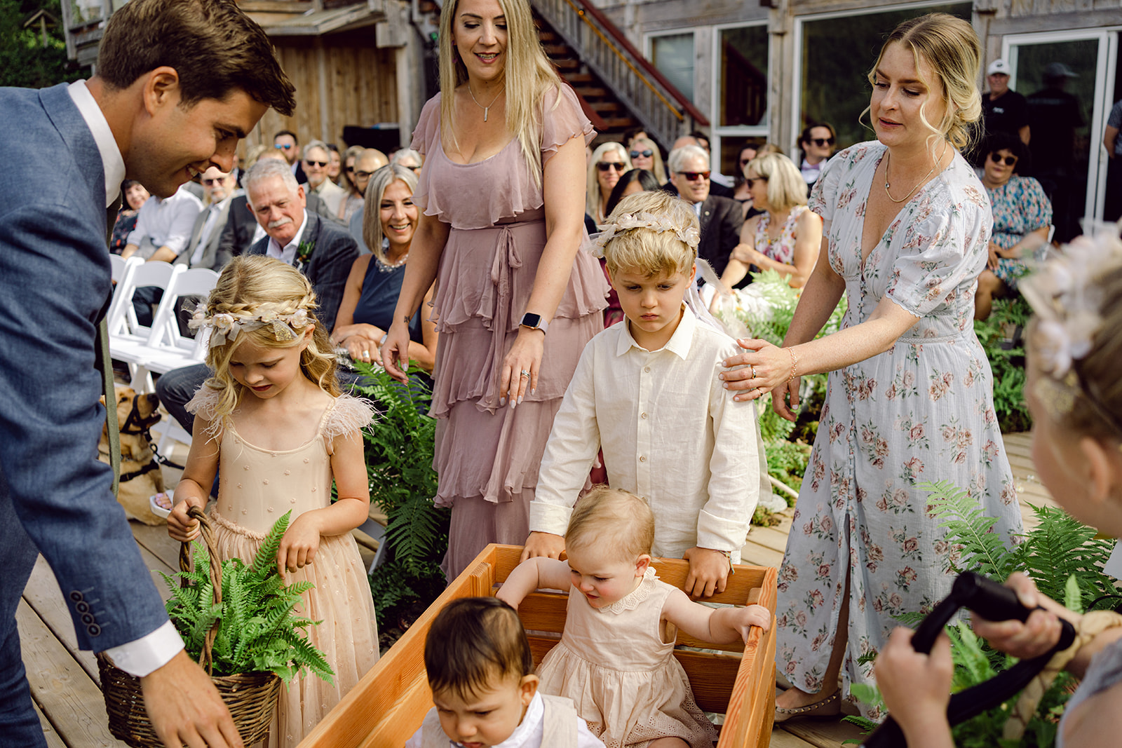 flower carriers and wedding kids coming down the aisle with kids in wagon