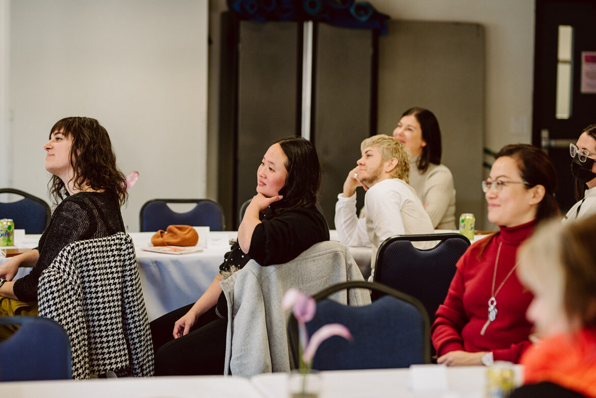 Vendors listen as their coworkers share highlights from their 2022 wedding season at the in-person Altared hosted in Portland, Oregon, on December 5, 2022.