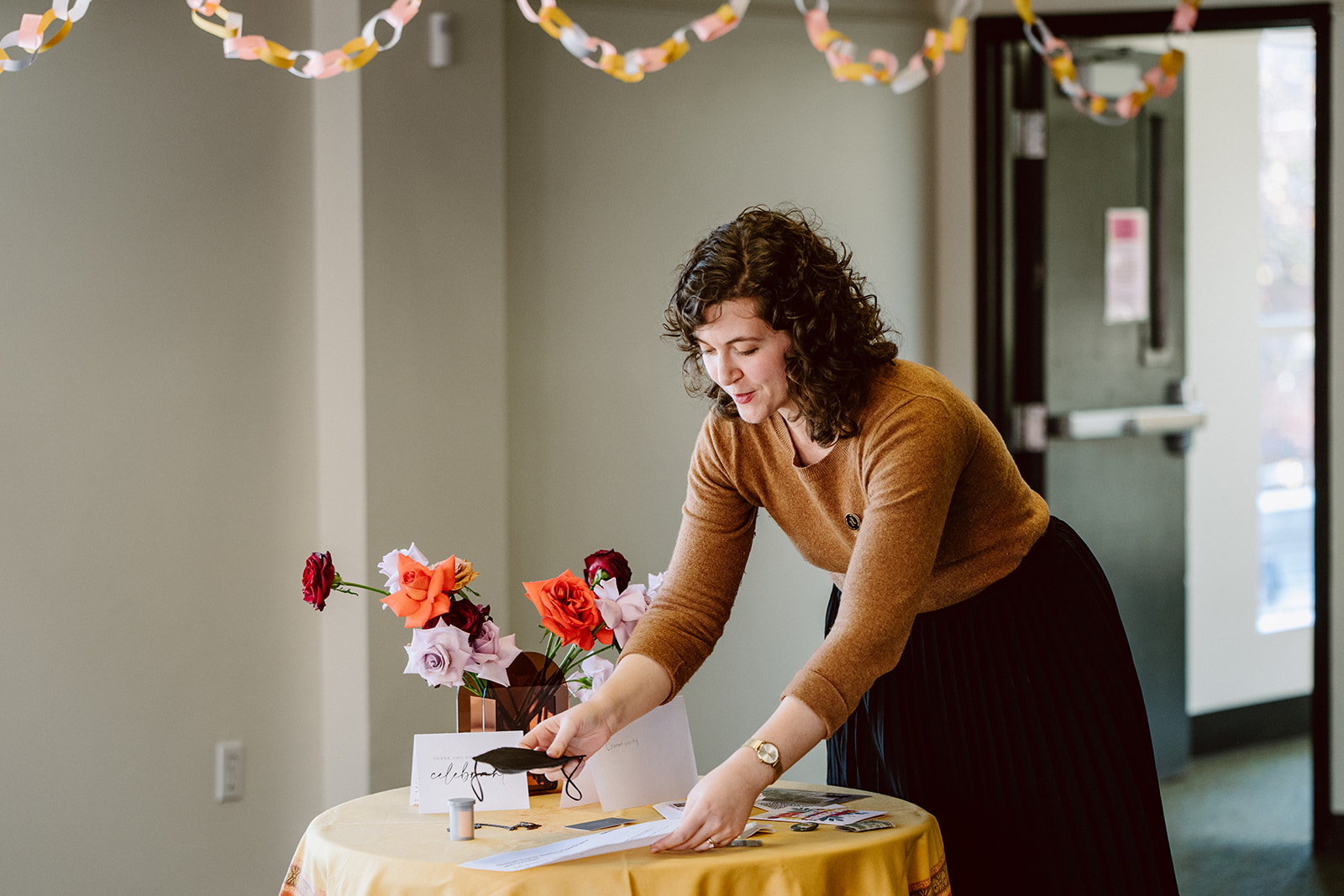 Altared co-founder Elisabeth Kramer places her item on the “joy altar” created at the in-person Altared hosted in Portland, Oregon, on December 5, 2022.