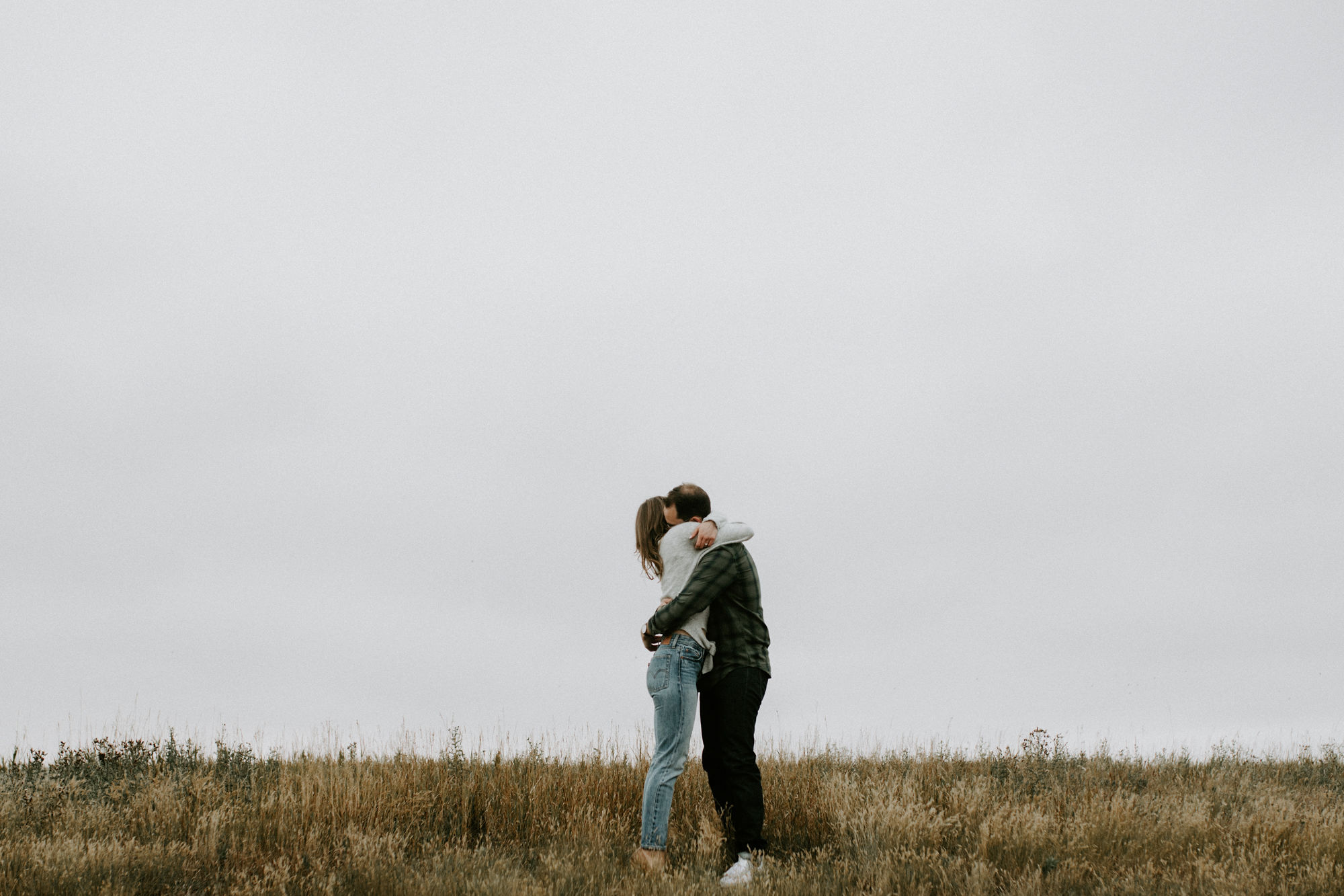 Couple in Nose Hill Park, Calgary photographed by Deanna Rachel Photography