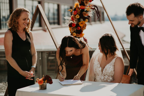 signing your marriage licence at your wedding ceremony with young hip and married wedding officiants