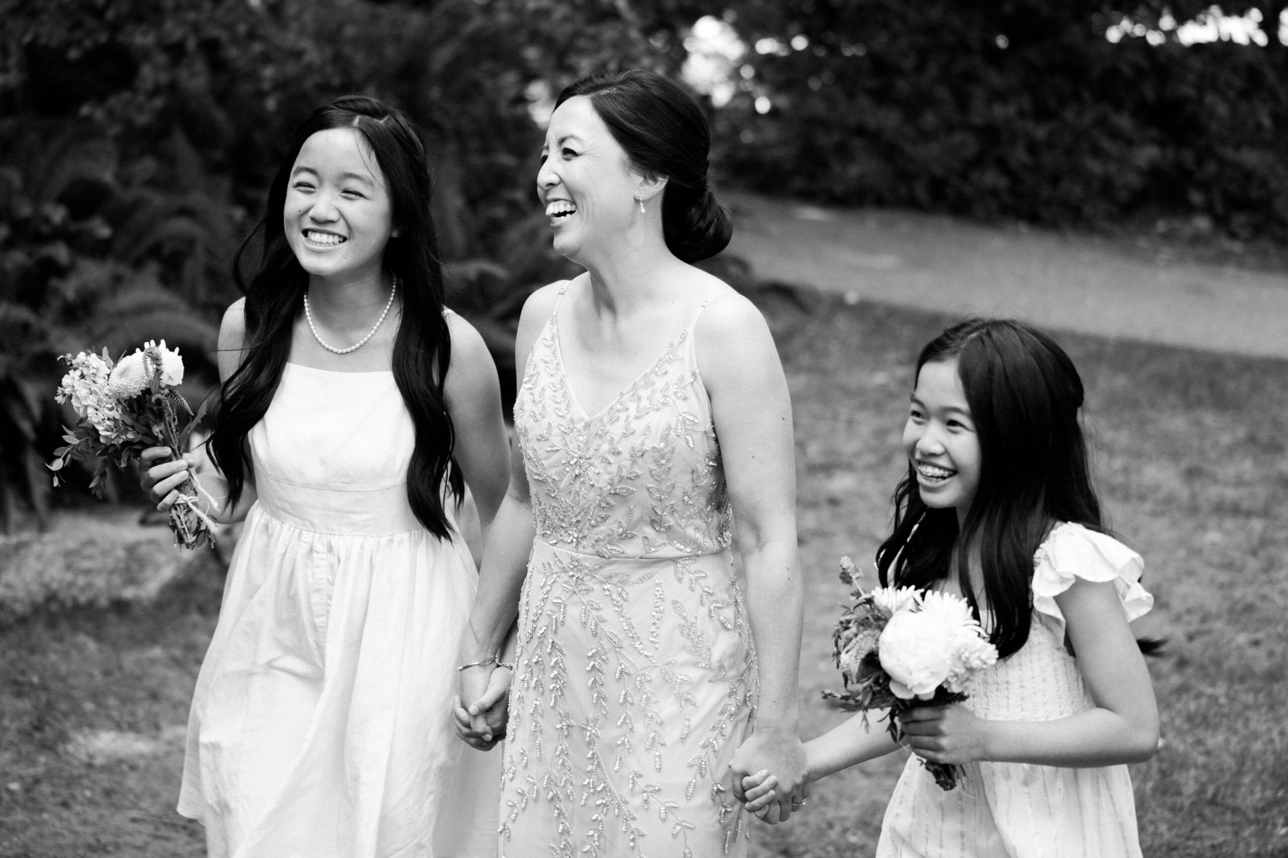 mother and daughters laughing on wedding day