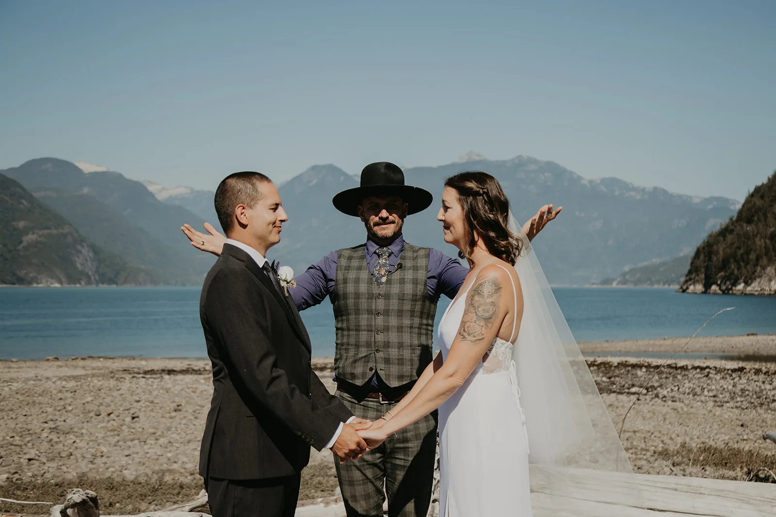 Wedding officiant opening a ceremony, we are gathered here today, Young Hip & Married beach elopement